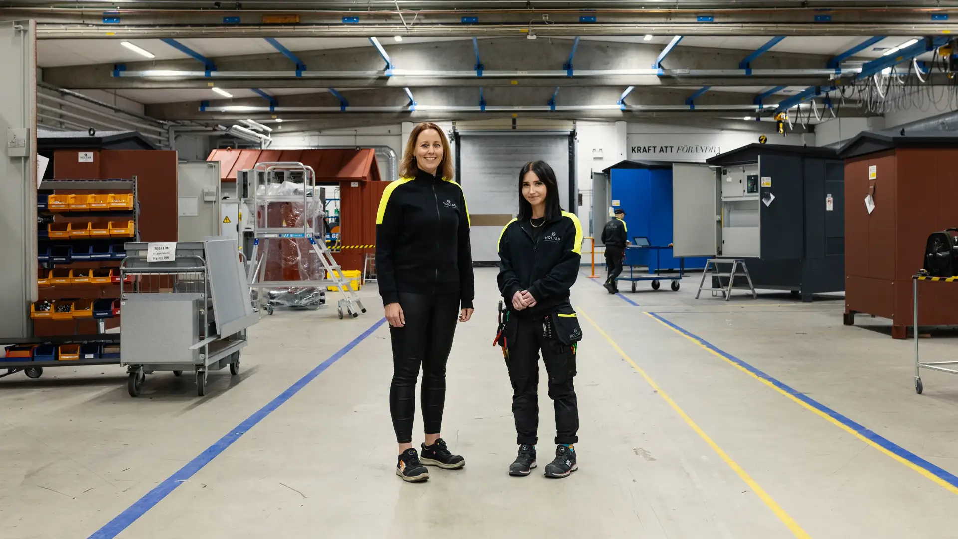 Martina Karlsson, HR-partner och Maja Färm, elmontör, står i produktionen på Holtab